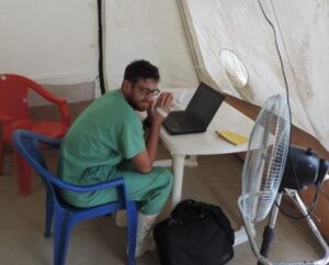 Temperatures reach 100°F inside full protective equipment. Here, Nick takes a brief break in the 90°F tent.